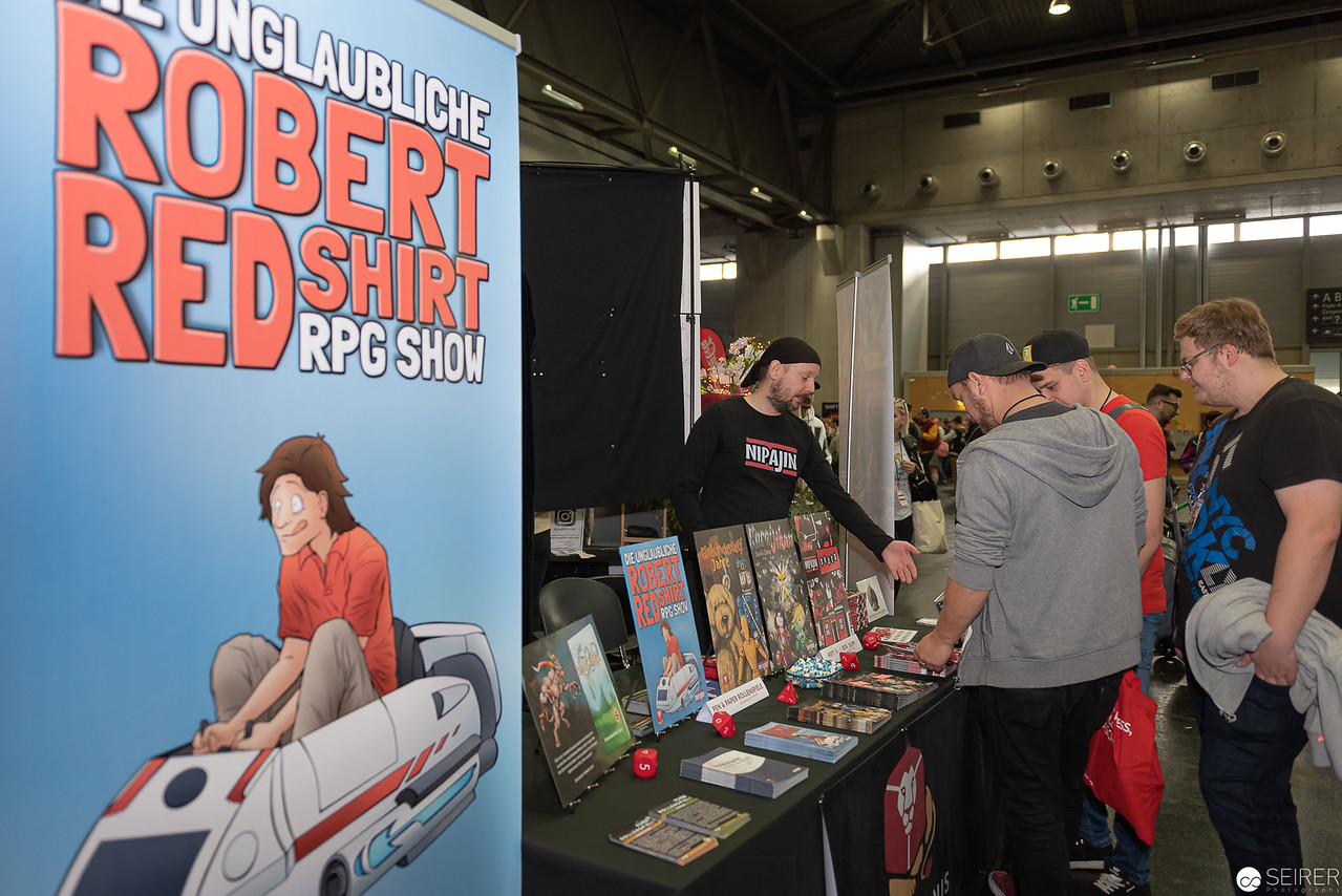 <p><a href="https://galleries.seirer-photography.com">seirer-photography</a><br />Robert Redshirt RPG Show Booth at Comic Convention Displaying Tabletop Gaming Materials</p><p><a href="https://galleries.seirer-photography.com/Events/2019/VIECC/Vienna-ComicCon-2019/i-mj7NN8Q" title="Robert Redshirt RPG Show Booth at Comic Convention Displaying Tabletop Gaming Materials"><img src="https://galleries.seirer-photography.com/Events/2019/VIECC/Vienna-ComicCon-2019/i-mj7NN8Q/0/Kb6znRGR2HGr9nZr7NVrgm4c9wThmLpDG8Tmx5wgK/Th/20191123_125719-viecc_9626-Th.jpg" width="150" height="150" alt="Robert Redshirt RPG Show Booth at Comic Convention Displaying Tabletop Gaming Materials" title="Robert Redshirt RPG Show Booth at Comic Convention Displaying Tabletop Gaming Materials" style="border: 1px solid #000000;" /></a></p>