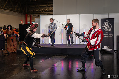 <p><a href="https://galleries.seirer-photography.com">seirer-photography</a><br />Historical European Fencing Demonstration at Vienna ComicCon 2024</p><p><a href="https://galleries.seirer-photography.com/Events/2024/VIECC/TheBestPhotos/i-3shMthh" title="Historical European Fencing Demonstration at Vienna ComicCon 2024"><img src="https://galleries.seirer-photography.com/Events/2024/VIECC/TheBestPhotos/i-3shMthh/0/KzCGwBGqD5Q6xN8x6r6MMkV2WKb69bmdD7PX7mHFk/Th/20241123_133532_viecc_2575-Th.jpg" width="150" height="150" alt="Historical European Fencing Demonstration at Vienna ComicCon 2024" title="Historical European Fencing Demonstration at Vienna ComicCon 2024" style="border: 1px solid #000000;" /></a></p>