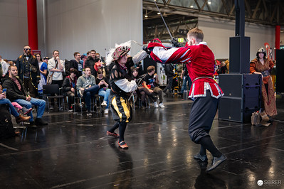 <p><a href="https://galleries.seirer-photography.com">seirer-photography</a><br />Medieval Combat Demonstration at Vienna ComicCon 2024 Historical Reenactment Stage</p><p><a href="https://galleries.seirer-photography.com/Events/2024/VIECC/TheBestPhotos/i-MbK7xrZ" title="Medieval Combat Demonstration at Vienna ComicCon 2024 Historical Reenactment Stage"><img src="https://galleries.seirer-photography.com/Events/2024/VIECC/TheBestPhotos/i-MbK7xrZ/0/Kqv2tttbPL5R4KkzZvZCSKqRQSBW7CXdSXJ4PJNPP/Th/20241123_132908_viecc_2252-Th.jpg" width="150" height="150" alt="Medieval Combat Demonstration at Vienna ComicCon 2024 Historical Reenactment Stage" title="Medieval Combat Demonstration at Vienna ComicCon 2024 Historical Reenactment Stage" style="border: 1px solid #000000;" /></a></p>